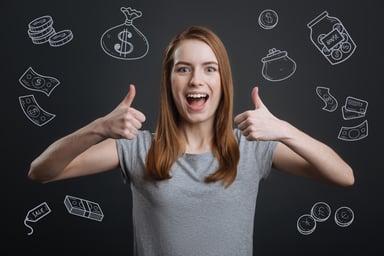 Young woman holding thumbs up