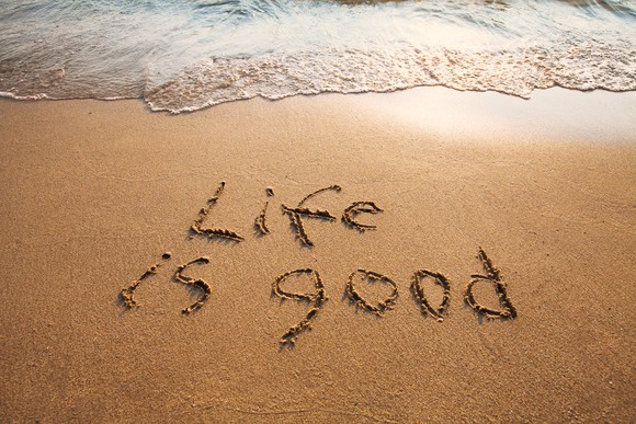 "Life is good" written in the sand