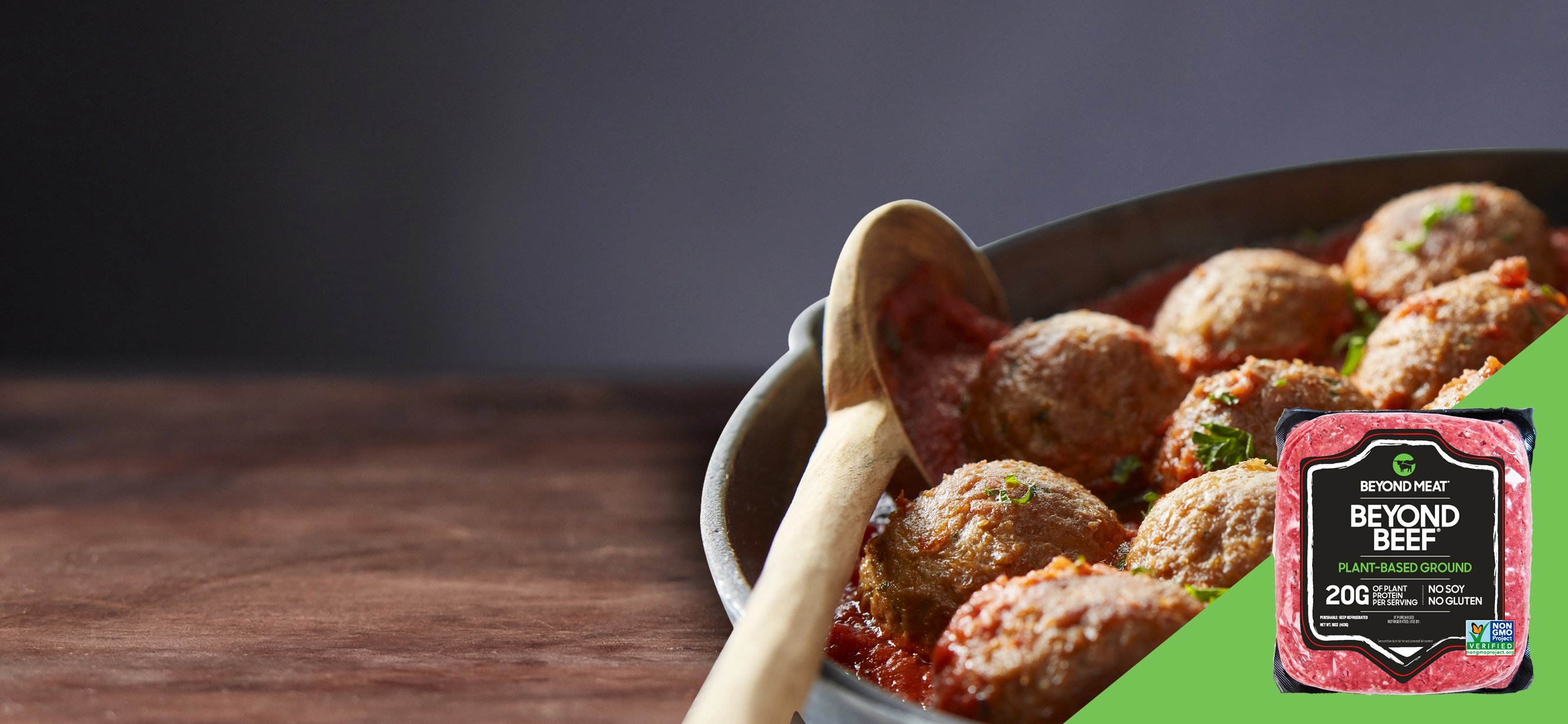 A Beyond Beef promo, showing meatball substitute and a wooden spoon in a pan.