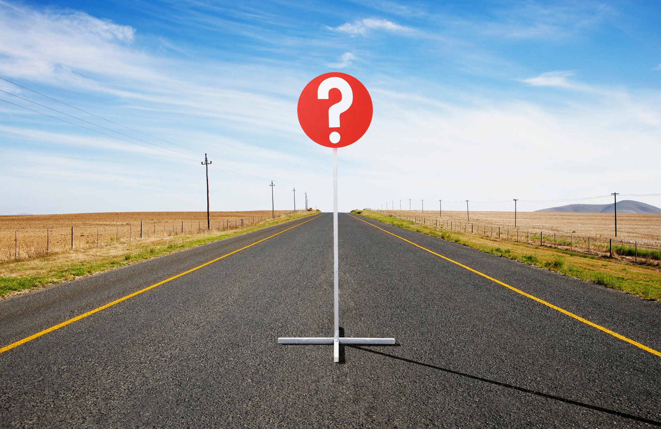 Question mark sign in the middle of the road.