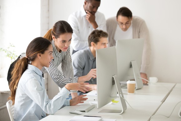 Group of employees being trained via computers