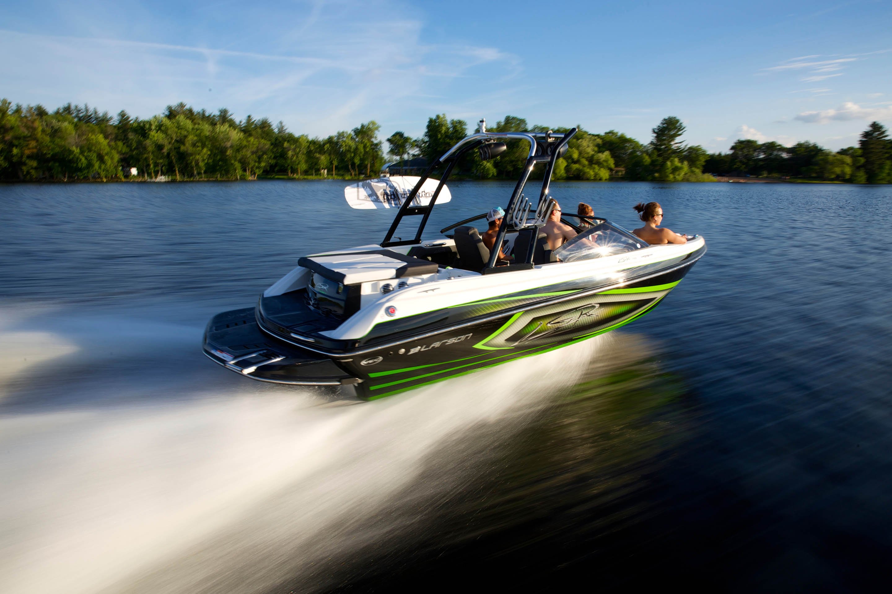 People on speedboat on lake