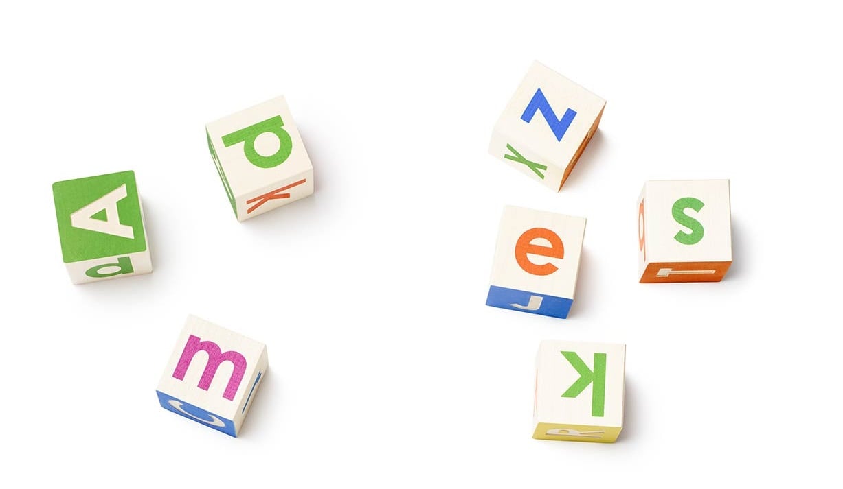 Seven alphabet blocks showing different-colored letters.