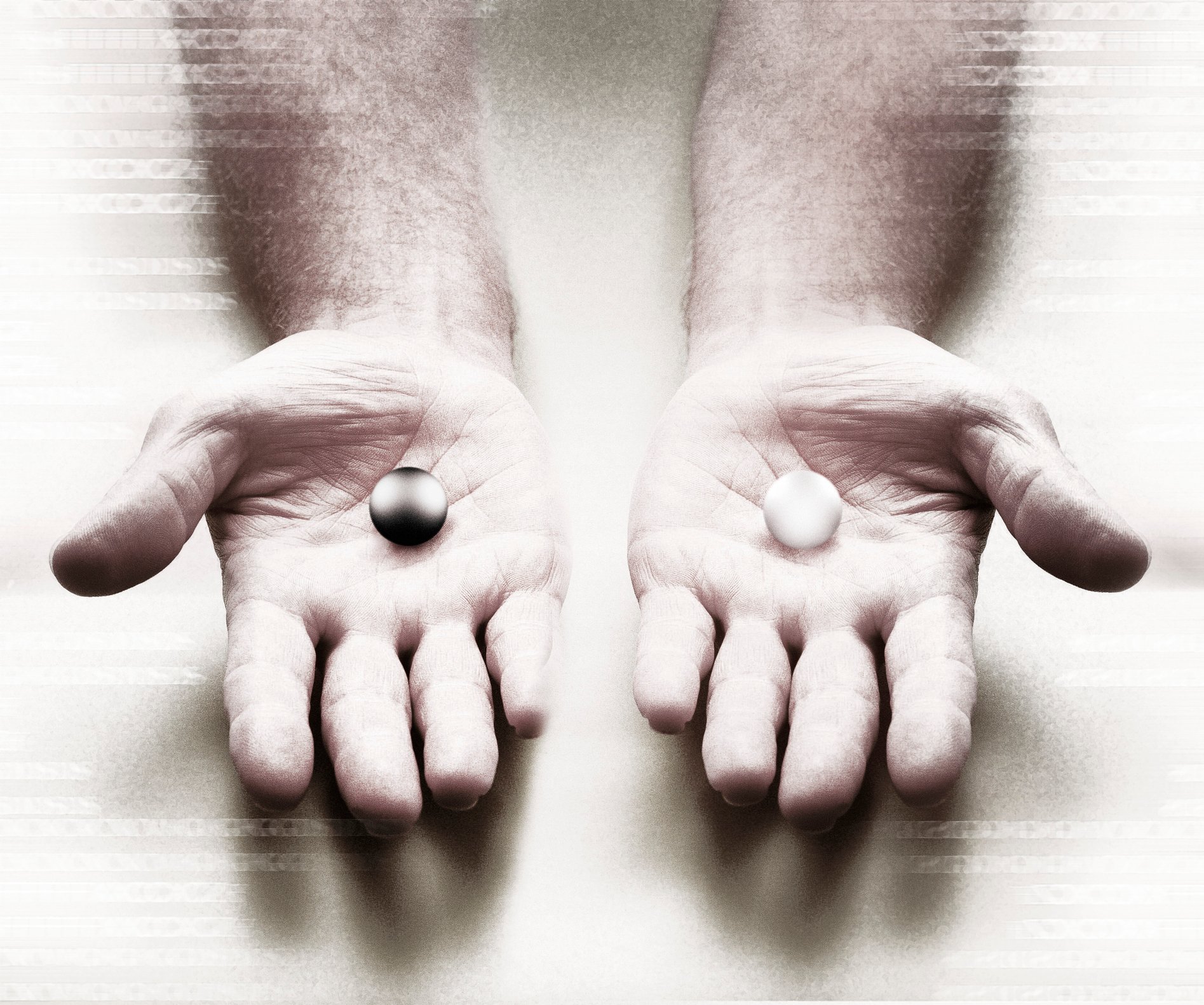 Two hands holding different-colored marbles