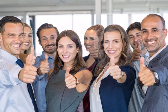A group of businesspeople with their thumbs up