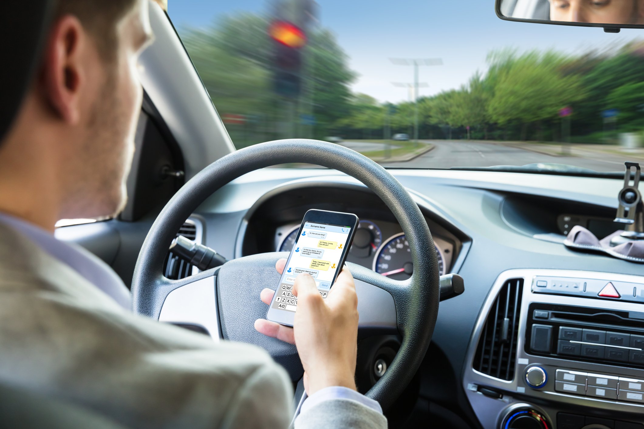 A man texts while driving.