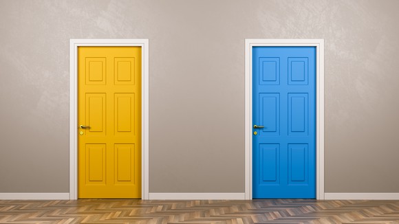 One yellow door and one blue door next to each other. 