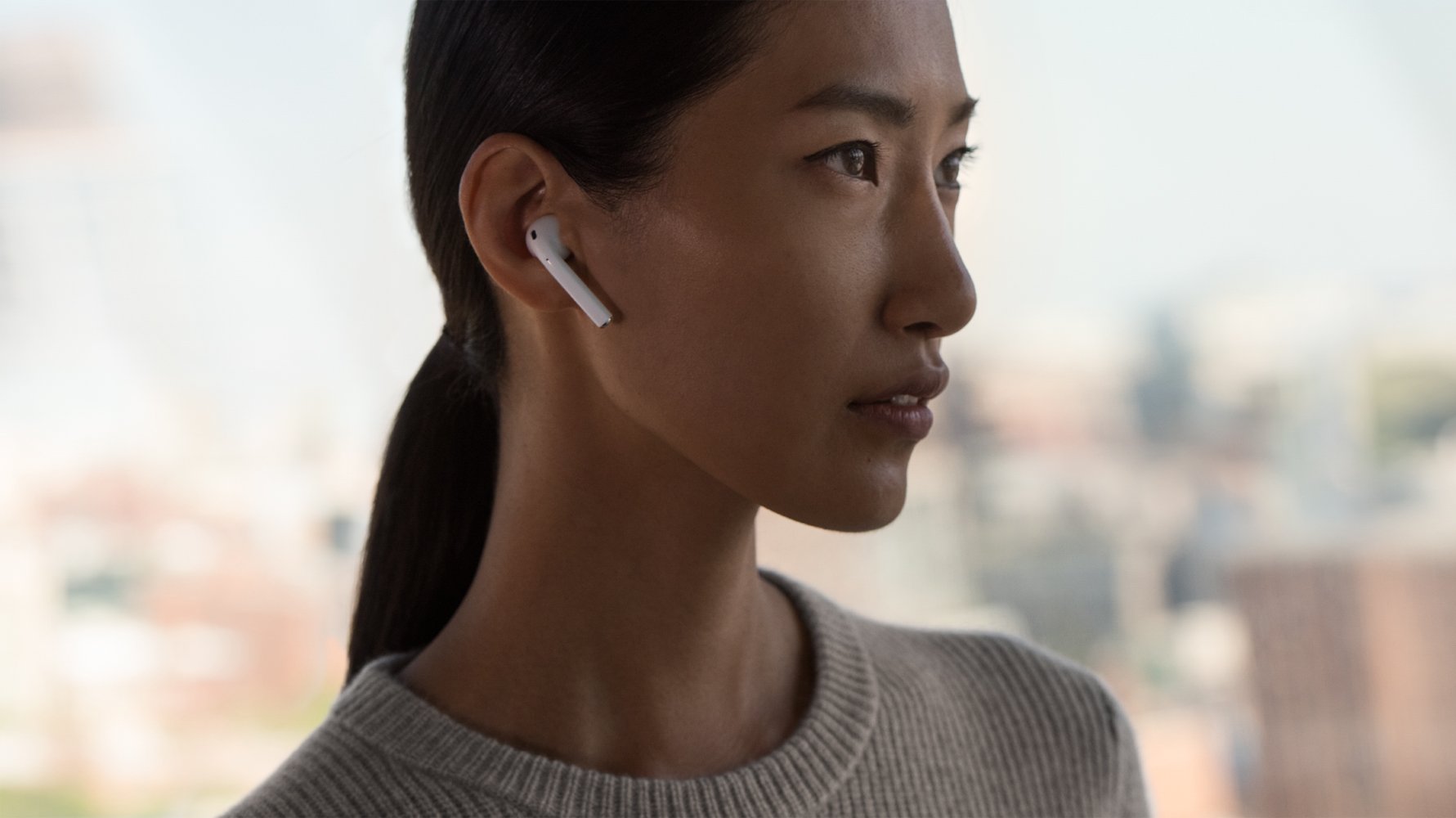 A woman wearing a pair of AirPods.