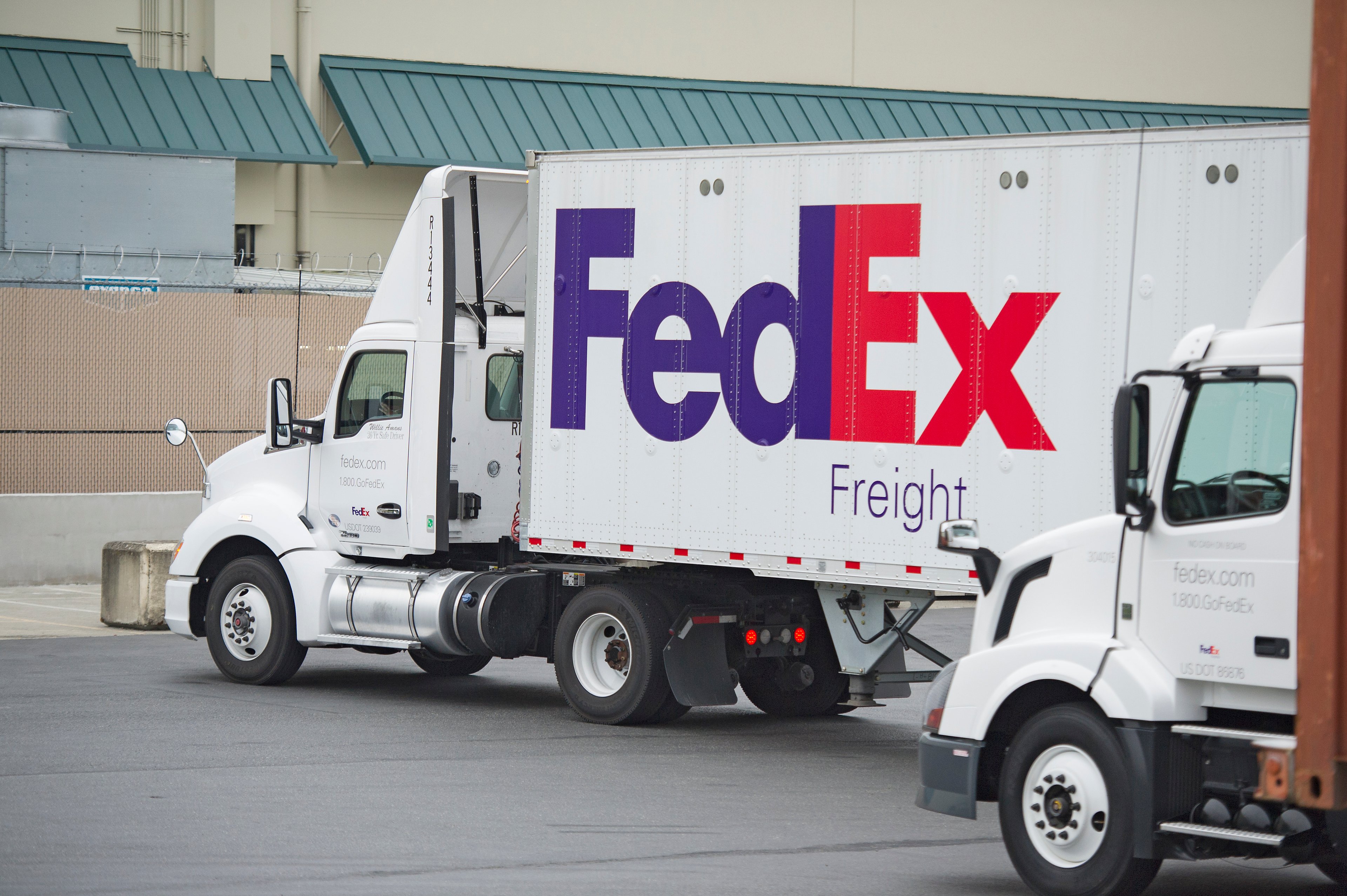 A FedEx truck waits at a terminal.