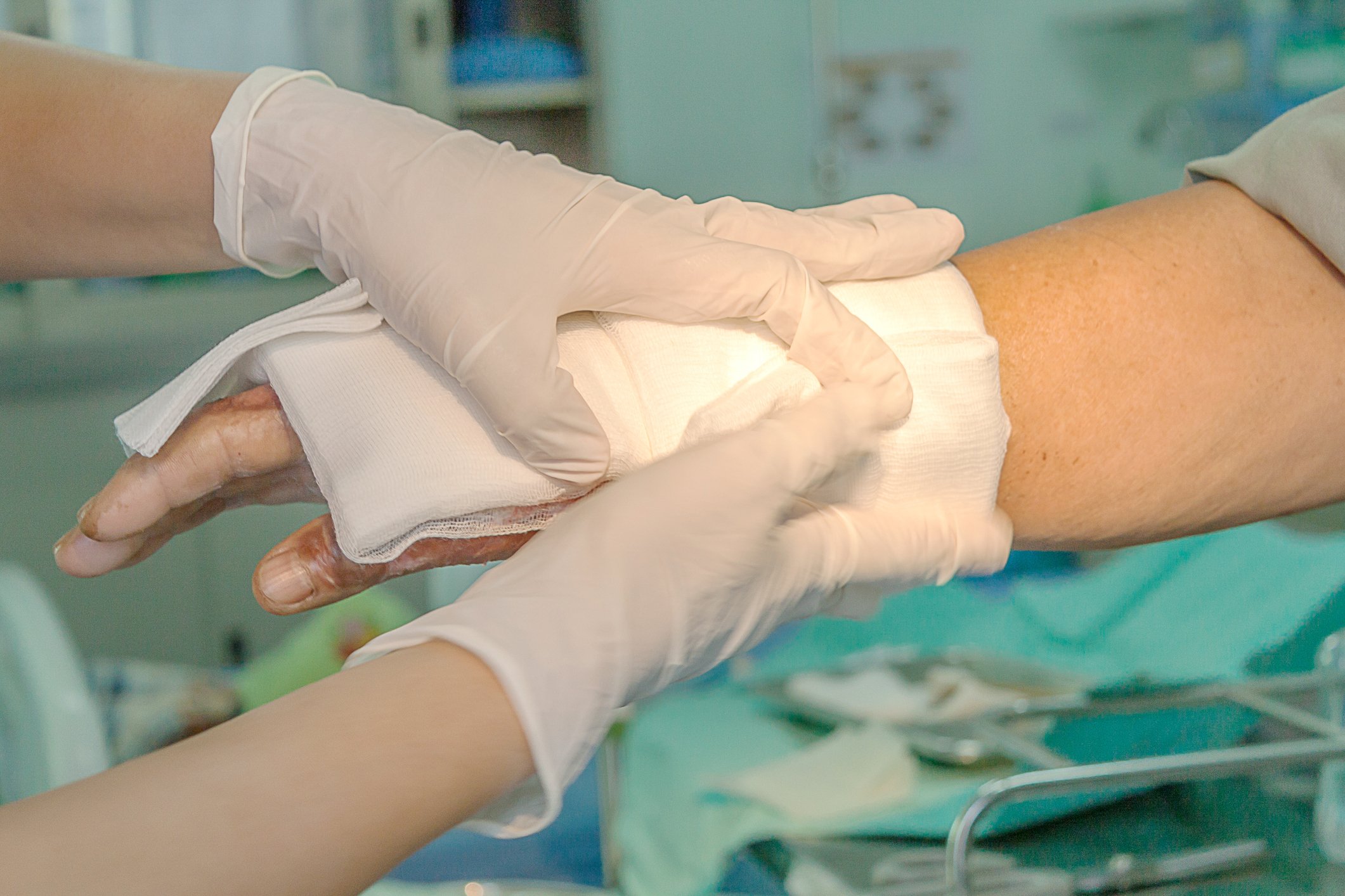 A doctor applying a bandage on an arm