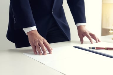Businessman standing in front of desk