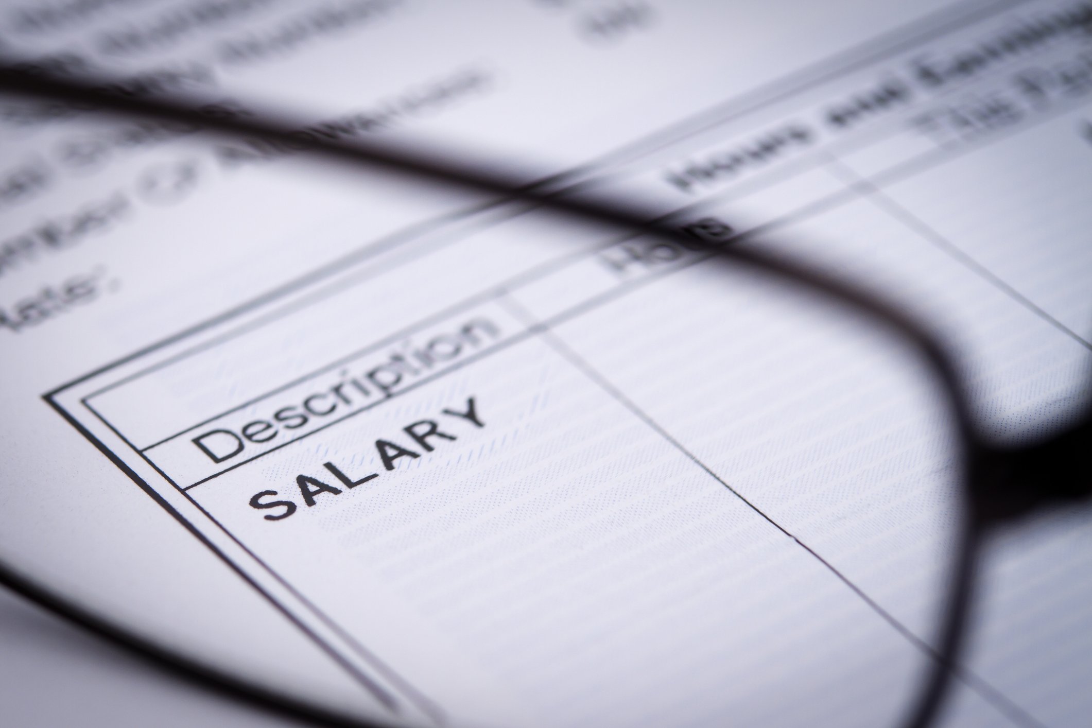 A person looks at a paycheck.