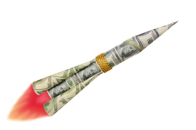 Rocket made out of dollar bills and gold