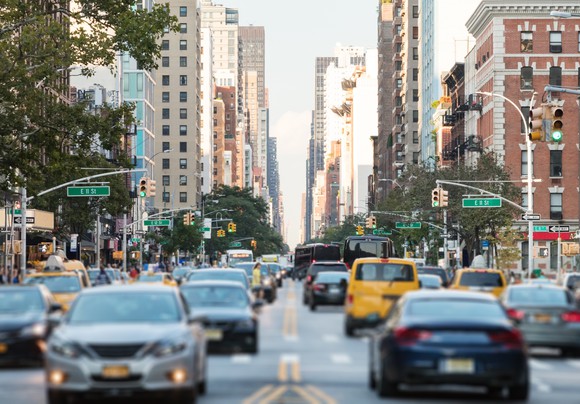 A New York City street with cars.