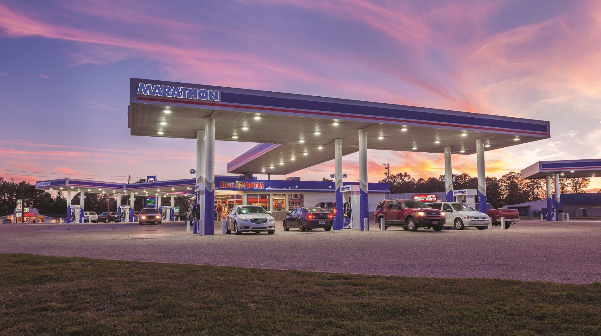 Gas station with Marathon awning near sunset.