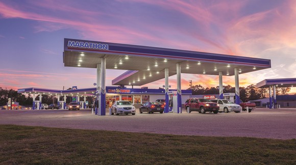 Gas station with Marathon awning near sunset.