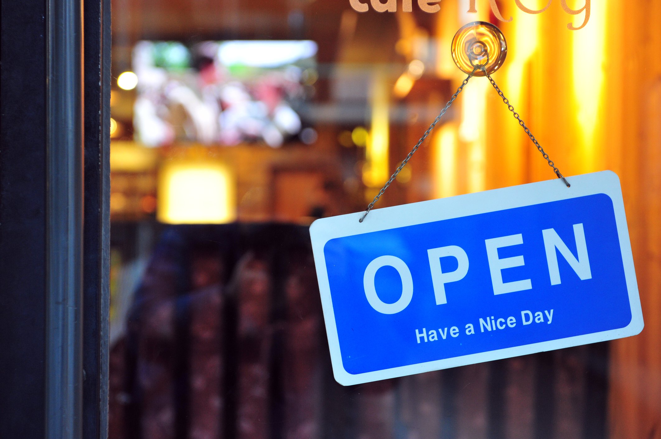 An open sign hangs on a door.