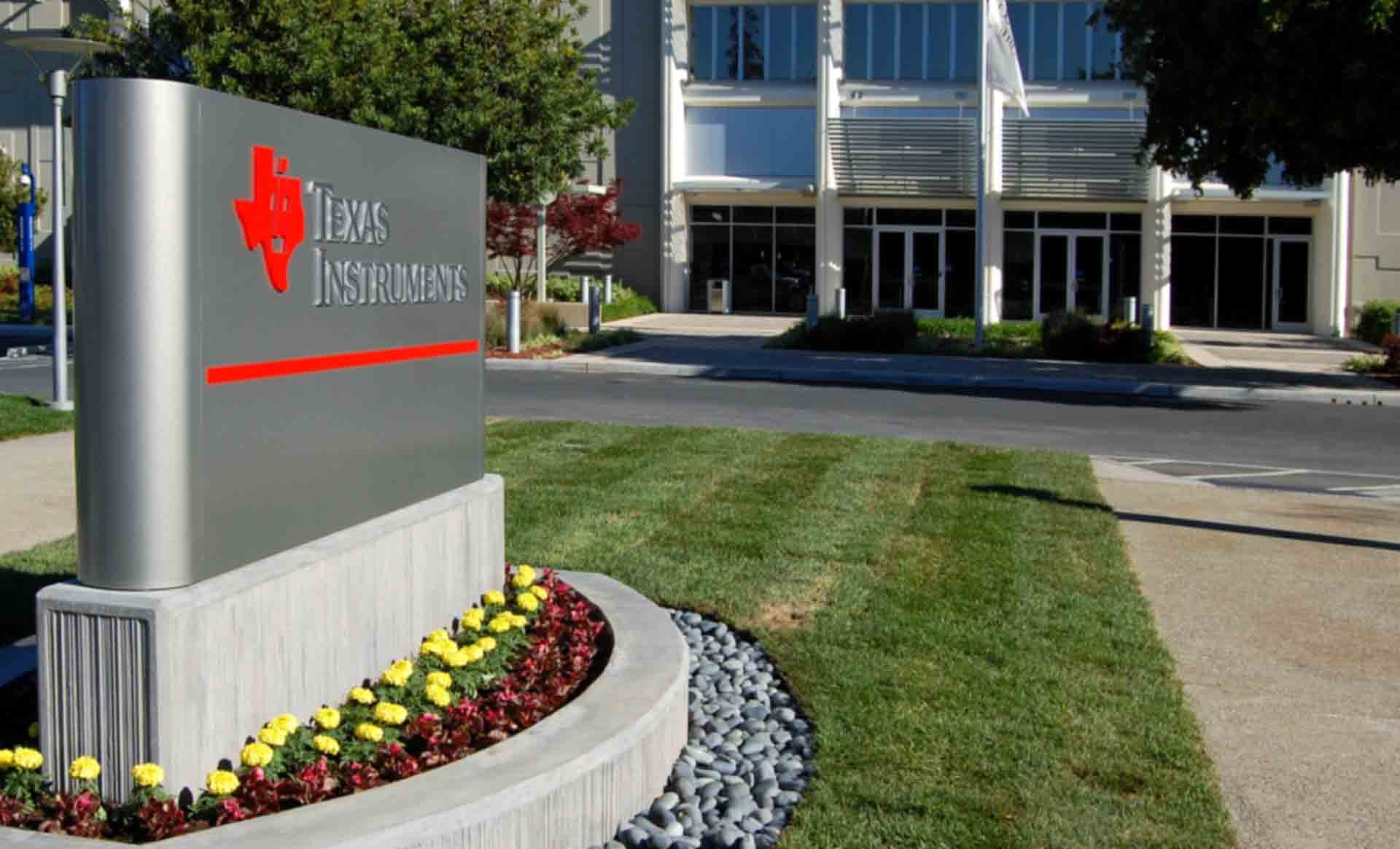 A sign that says Texas Instruments outside TI's headquarters in Dallas, Texas.