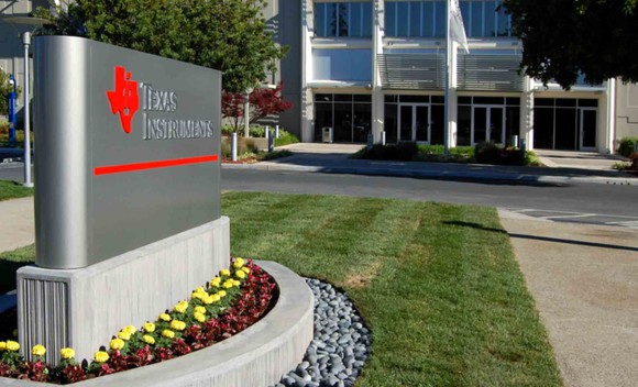 A sign that says Texas Instruments outside TI's headquarters in Dallas, Texas.