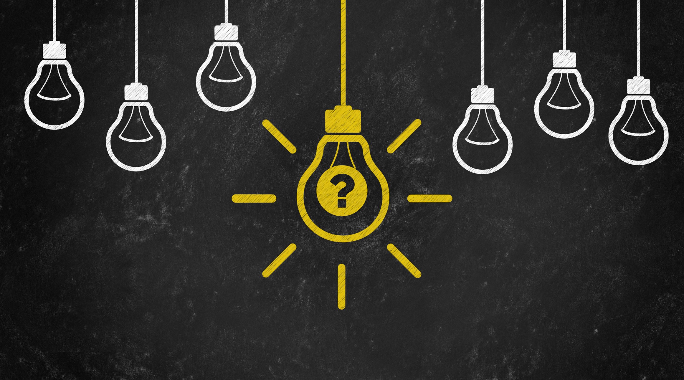 Chalkboard drawing of six small white light bulbs and one larger yellow light bulb with a question mark in the center of it