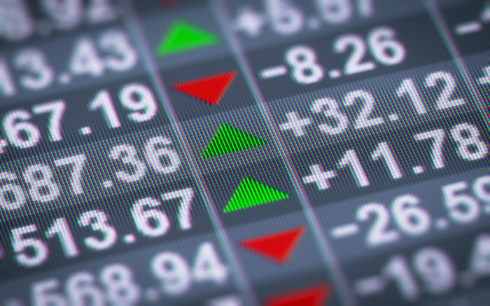 Stock data on an LED display with red and green arrows indicating direction.