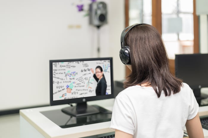 A woman takes an online course.