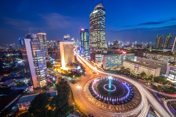 Photo of Indonesian capital Jakarta at night, highlighting bright lights and bustling traffic.