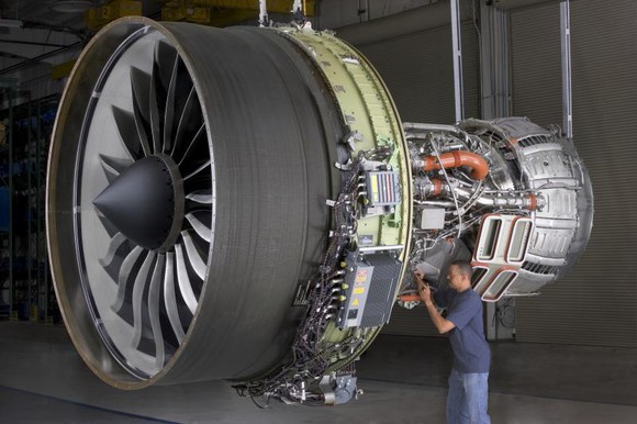 A worker inspects an aviation turbine