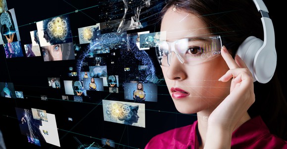 A woman wears headphones and glasses that show video images that fly by her face. 