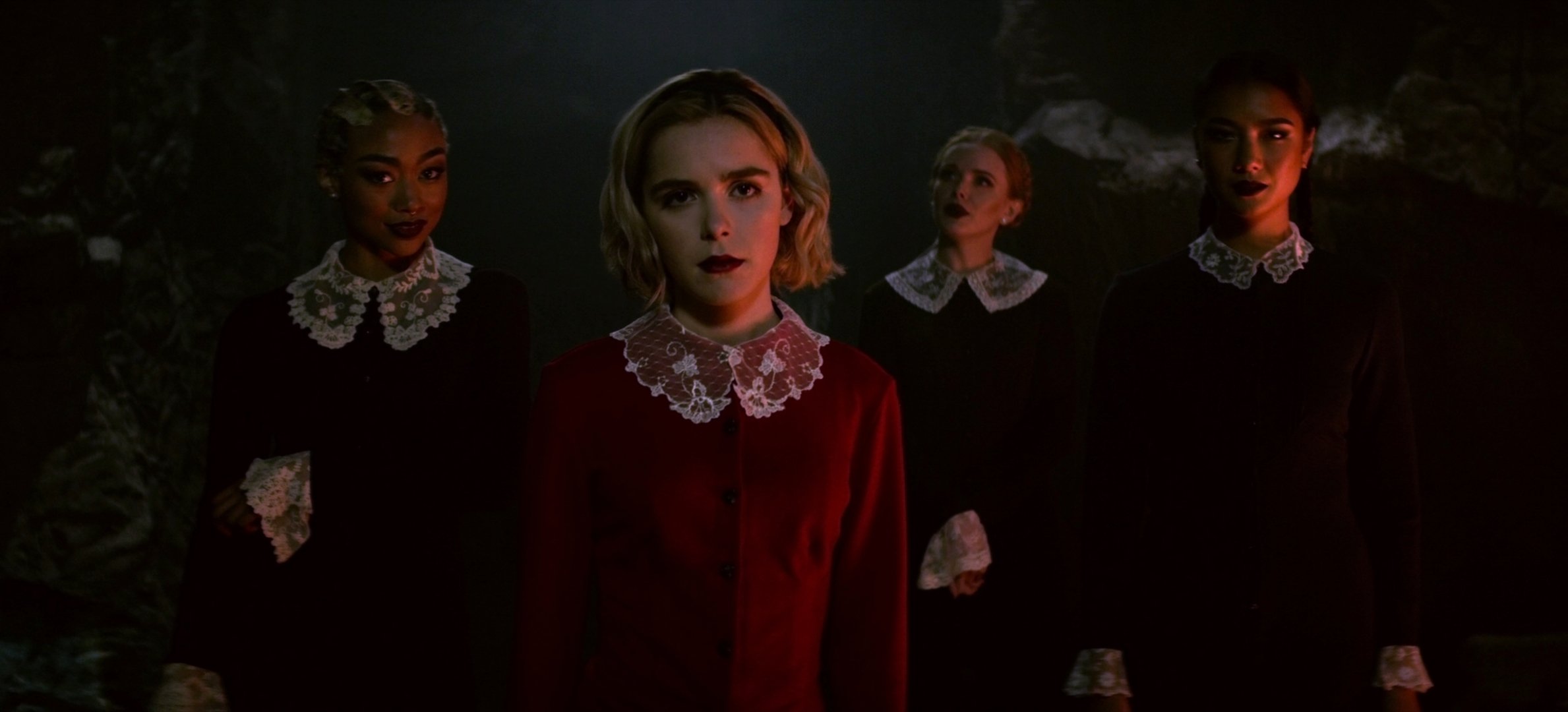 Tati Gabrielle, Kiernan Shipka, Abigail Cowen, and Adeline Rudolph in a scene from Netflix original series The Chilling Adventures of Sabrina.