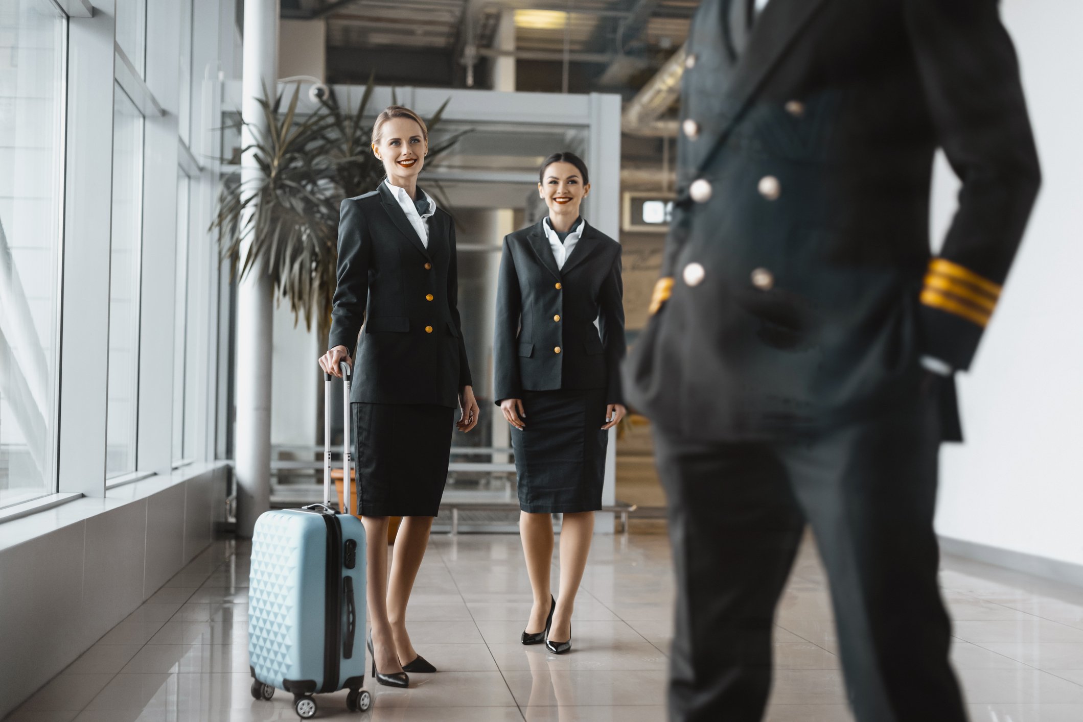 Flight attendants looking at a pilot