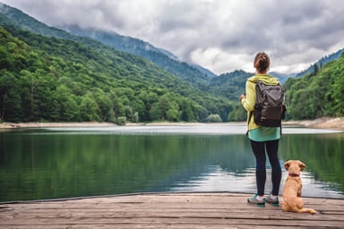 Female Hiker With Dog at Lake