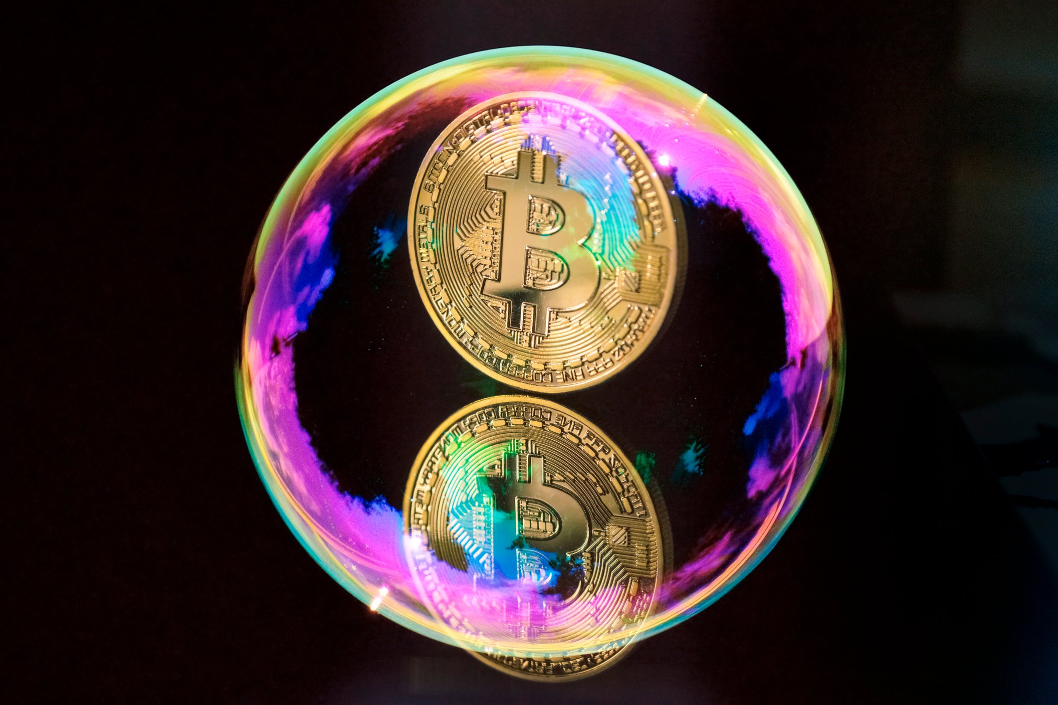 A gold coin with the bitcoin symbol on it, floating in a bubble.