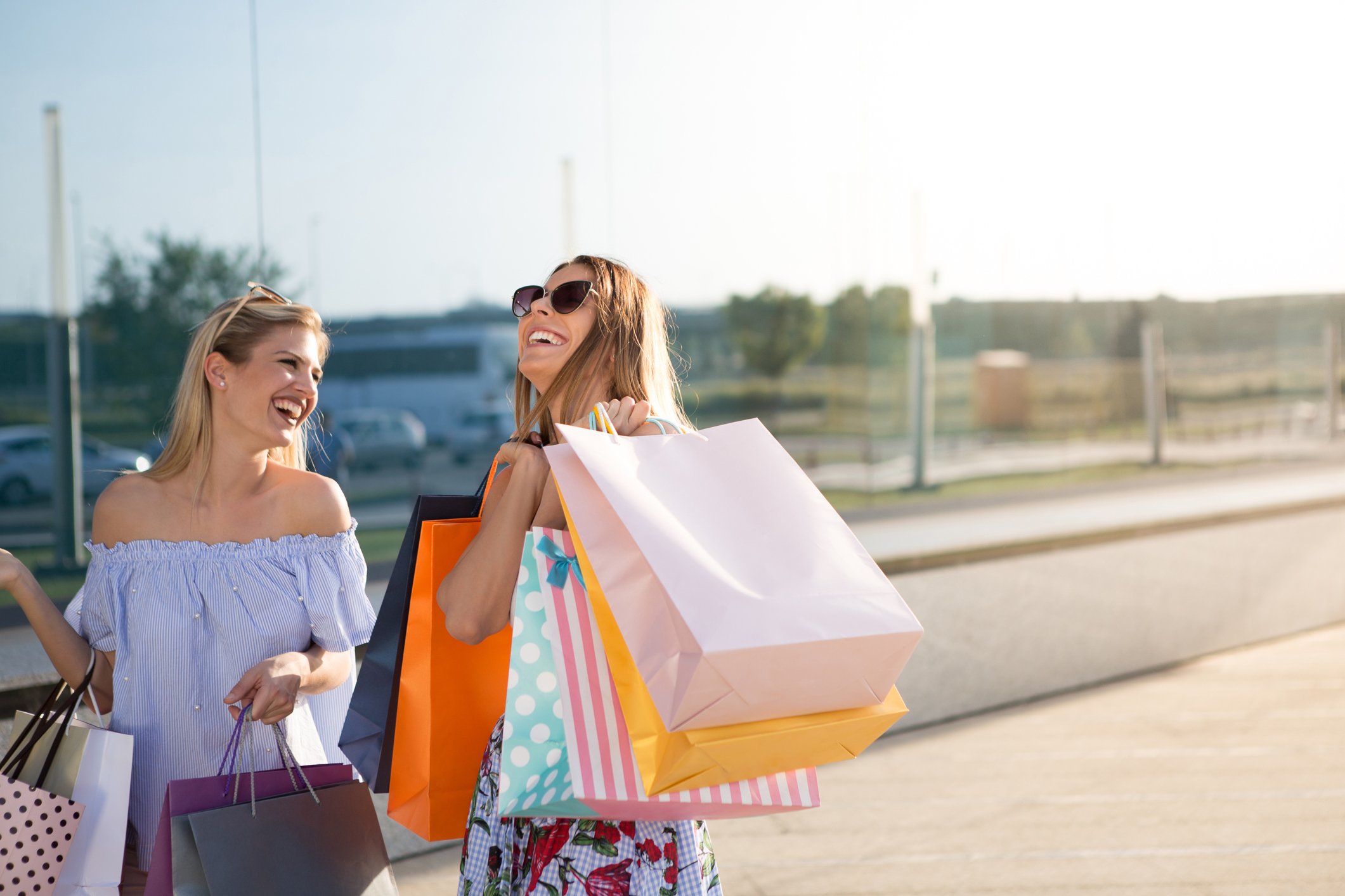 Two women with shopping bags.
