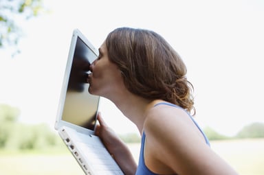 woman kissing laptop