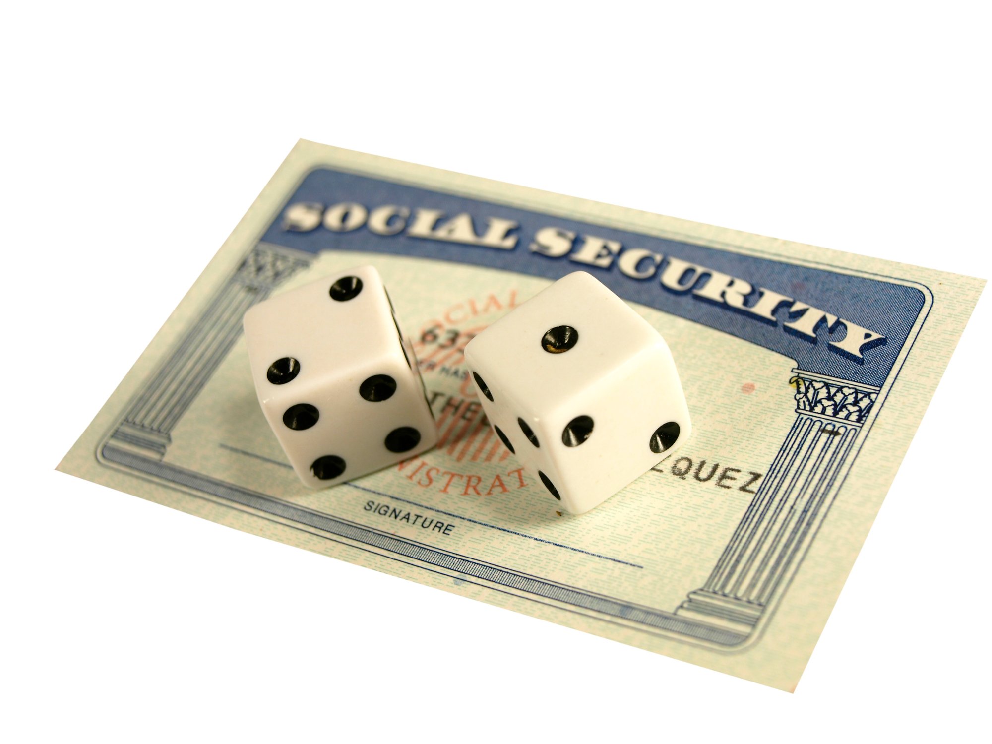 Two dice on top of a Social Security card.