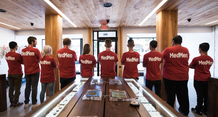 MedMen employees with the name of the company on the back of their shirts