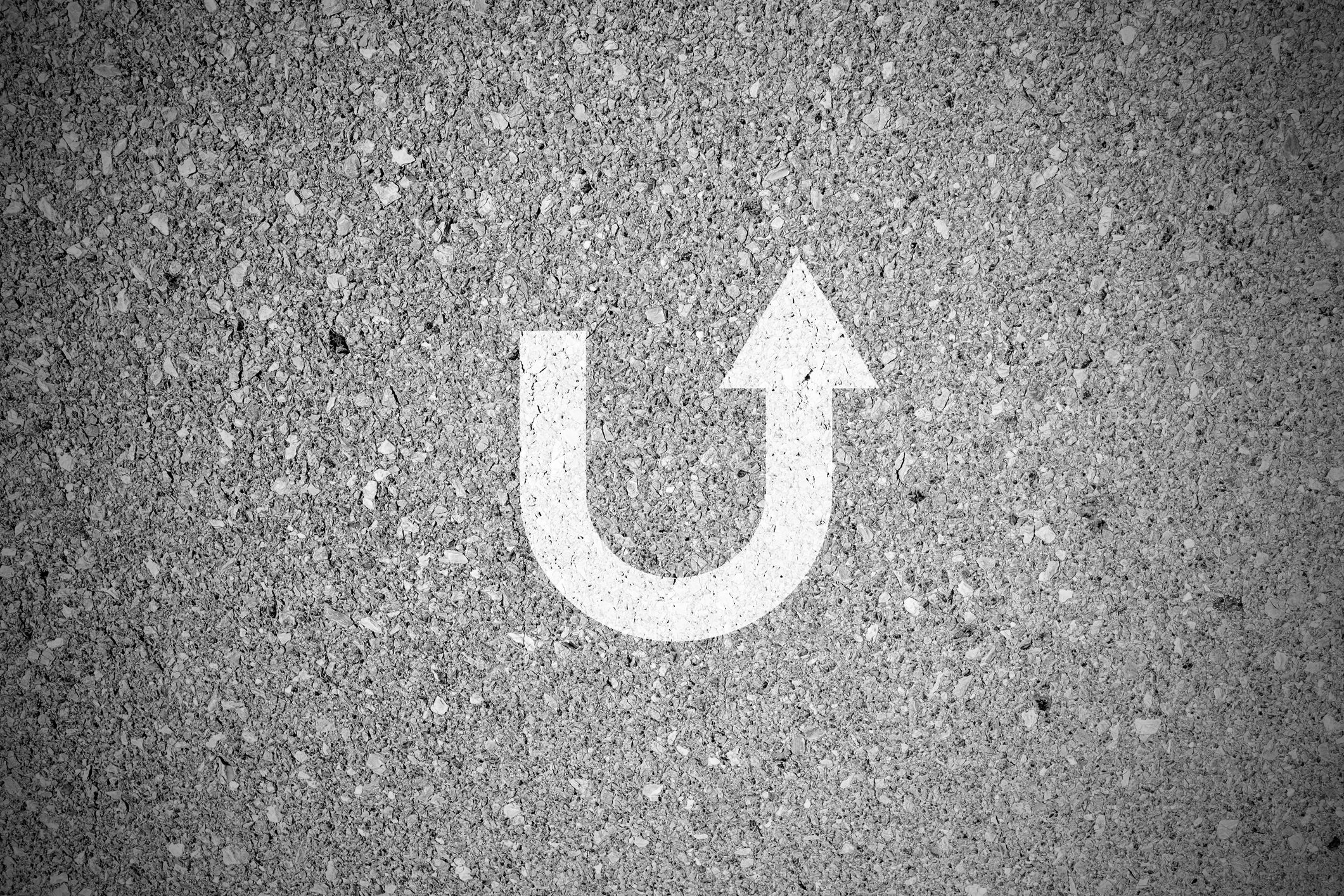 A U-turn arrow painted on pavement