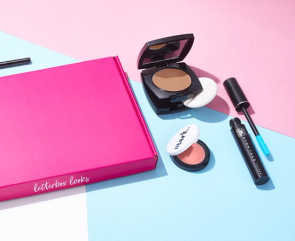 Avon foundation, blush, and mascara on a colorful table.