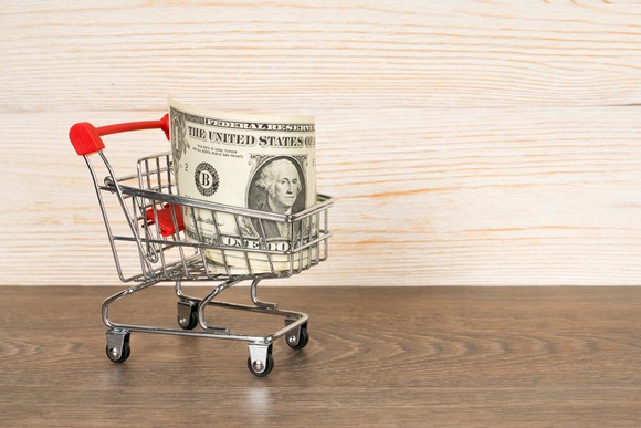 A dollar bill in a shopping cart.