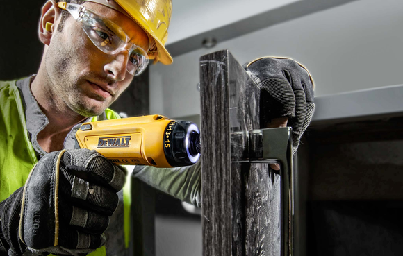 A man operating a power tool.