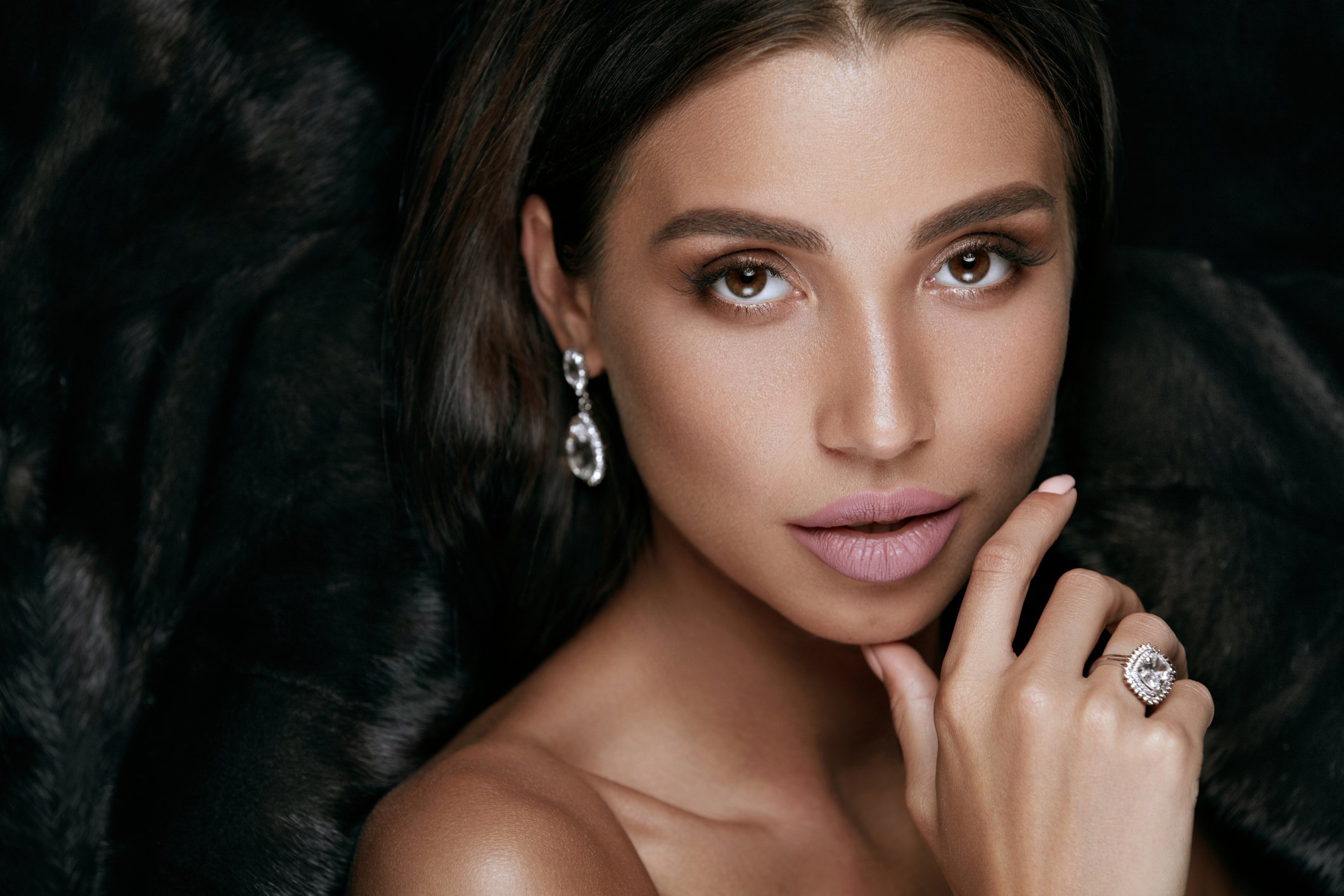 A woman wearing diamond jewelry.