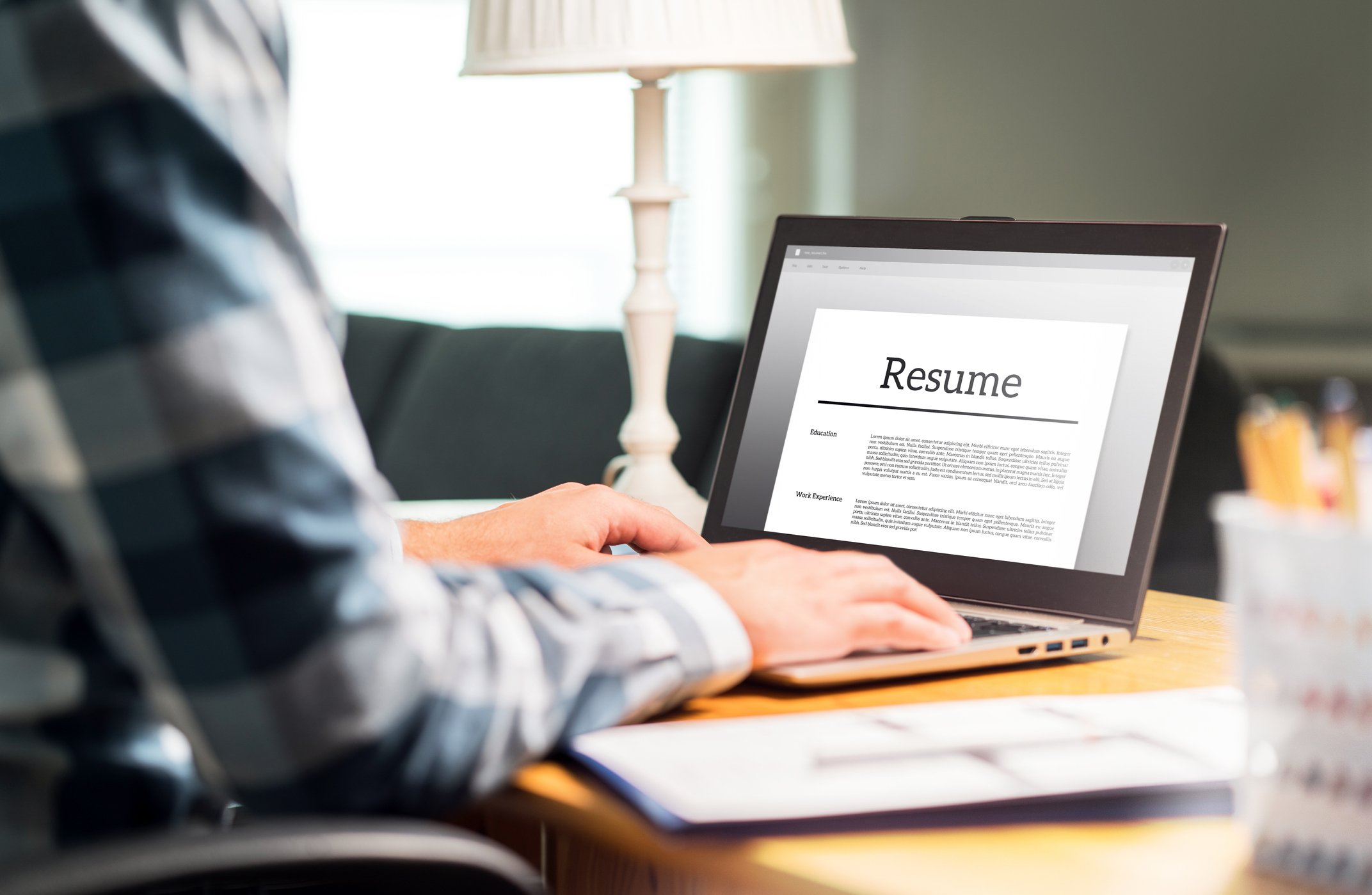 Man at laptop with resume on screen
