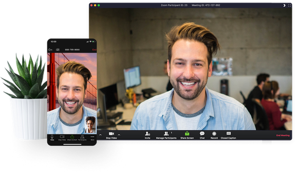 A computer screen and a cell phone screen showing a man with a couple people in front of computers in the background.