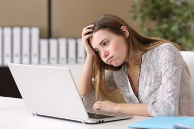 bored young woman at laptop_GettyImages-647280958