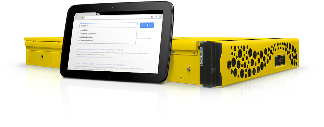 A photo of Google's original yellow and black search appliance with a small tablet stood up against the side