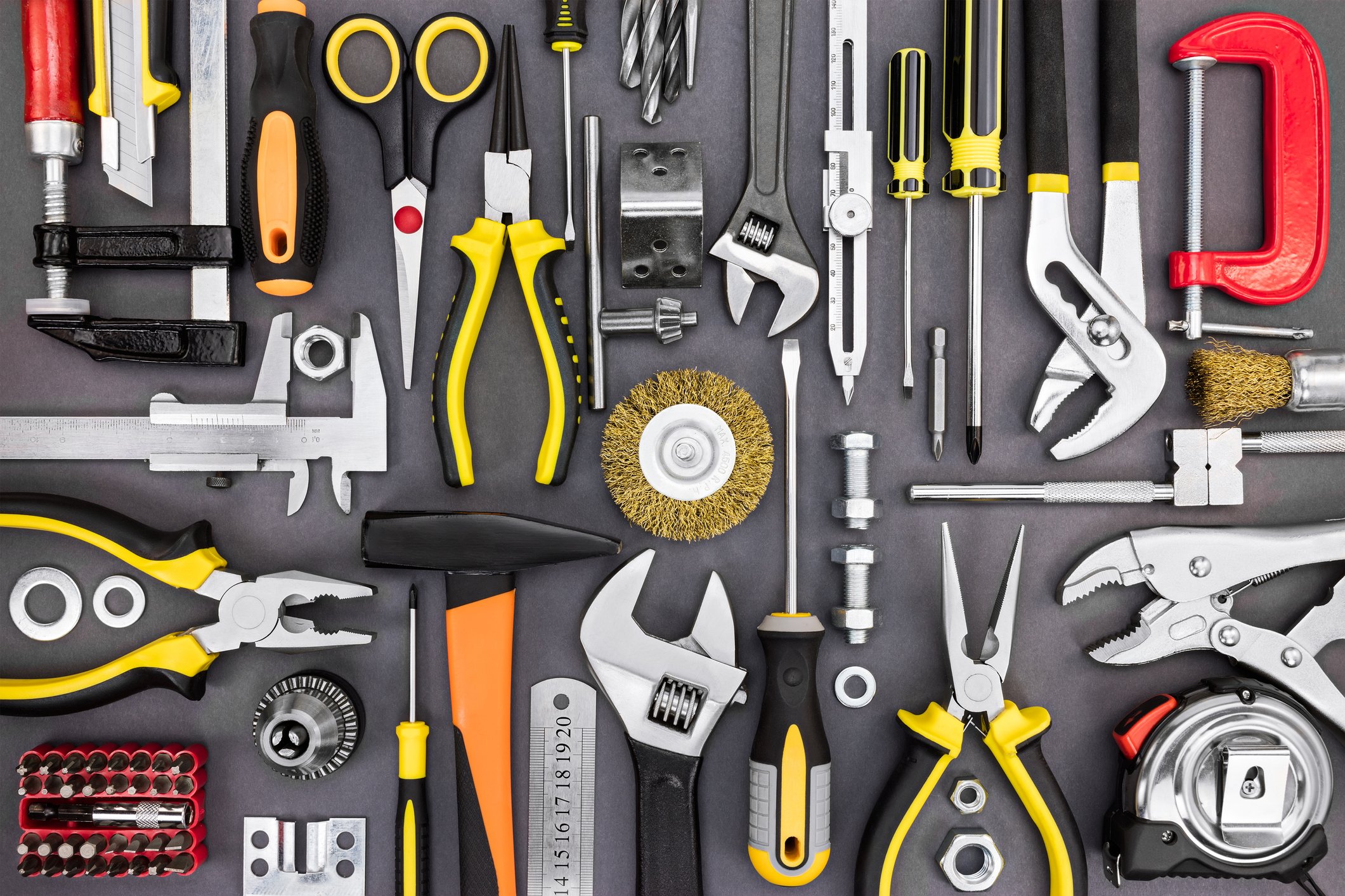 A collection of many tools on a gray surface