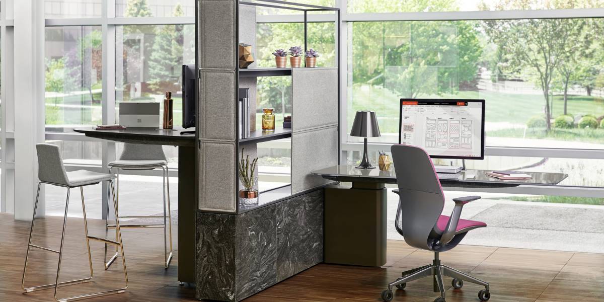 A contemporary open-plan office space facing a corporate garden.