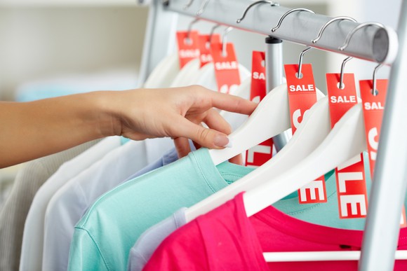 Woman looking at clothes marked for sale