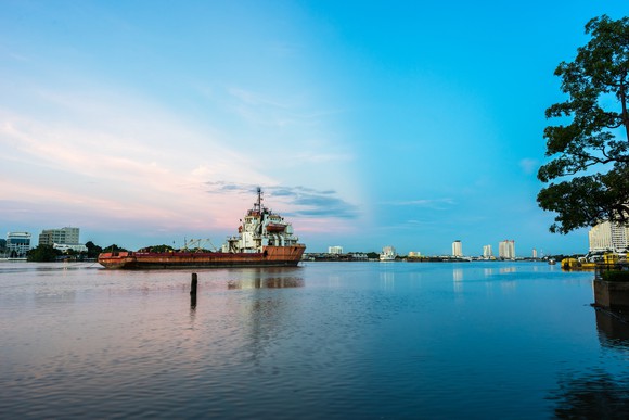 A large ship navigates a river.